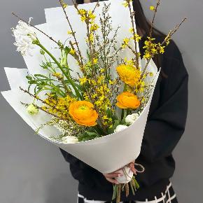 Весенний букет с желтыми ранункулюсами и цветущими ветками форзиции в Луховицах